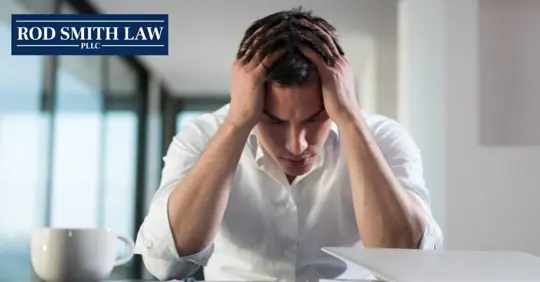 male employee holding his head